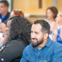 Alumni clapping at the event.